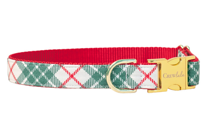 A festive dog collar with a green plaid pattern, featuring a bright interior lining. The collar is accented with polished hardware, including a D-ring and a side-release buckle engraved with the brand name “Crewlala".