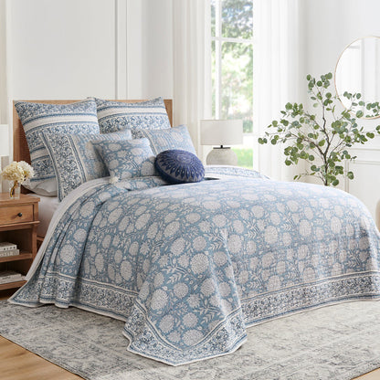 Bedroom with floral-patterned bedding and pillows