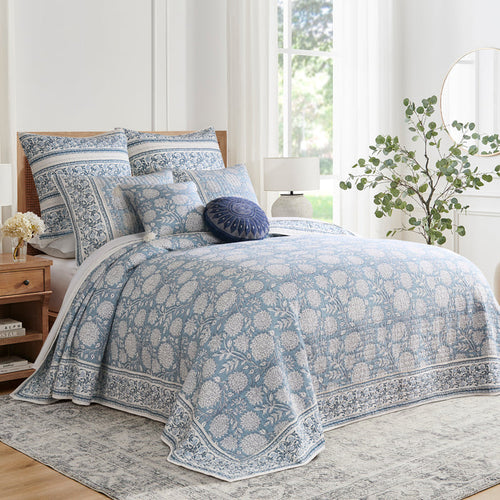 Bedroom with floral-patterned bedding and pillows