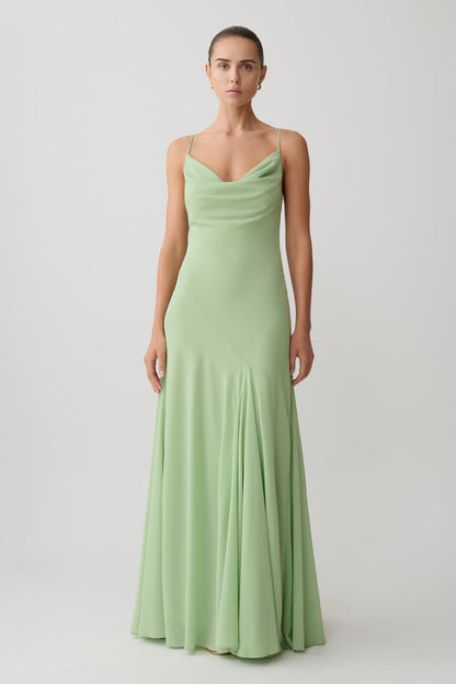 Woman wearing a light green chiffon maxi dress.