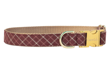 Burgundy dog collar with a light plaid design, complemented by a shiny metal buckle engraved with “Crewlala” and a matching D-ring for leash or tag attachment.