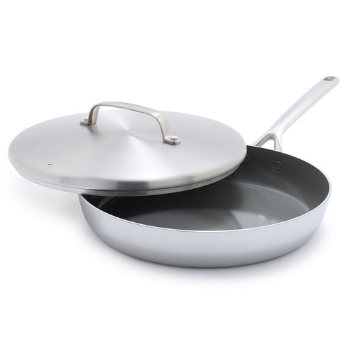 Stainless steel 12-inch frypan with shiny handles and a matching lid that sits slightly askew.