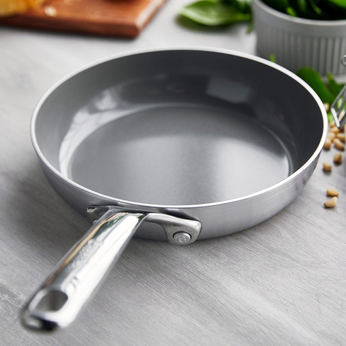 Stainless steel 8-inch frypan with a mirror handle sitting empty on a light gray countertop.