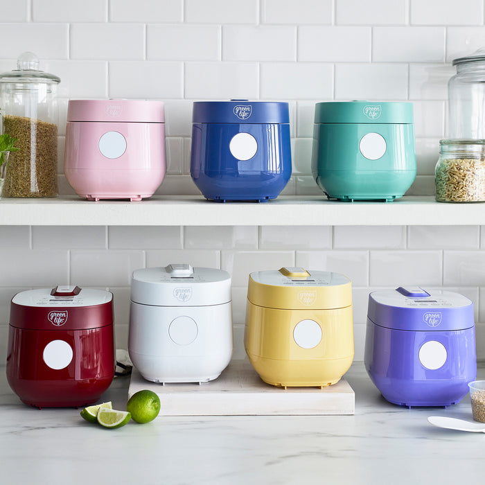Turquoise 4-cup rice and grains cooker with a ceramic interior and compact design.