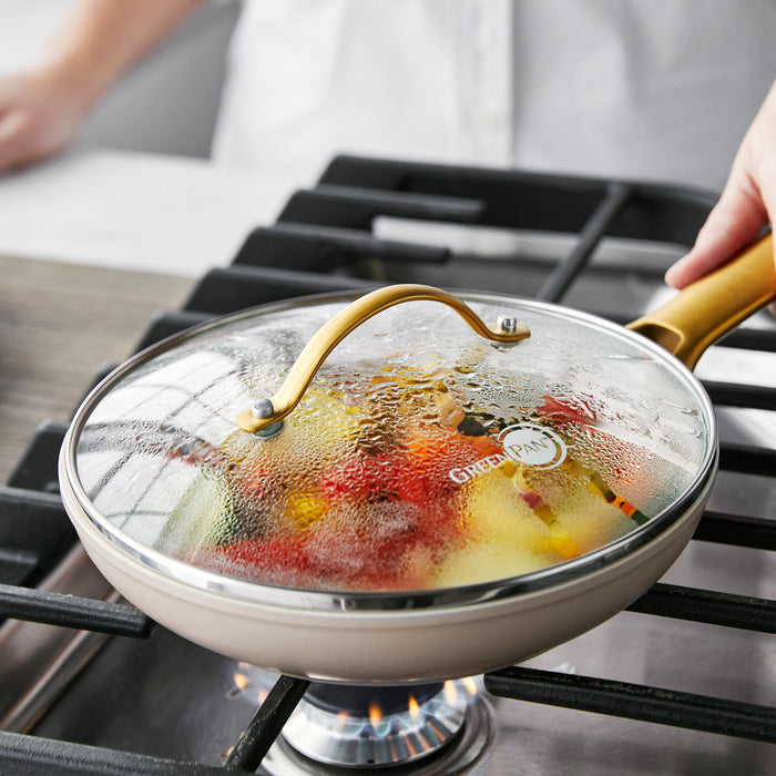 Vegetables cooking in a covered GreenPan Reserve 8-inch glass lid skillet with steam on the lid.