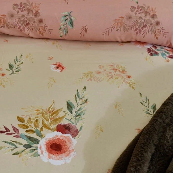 Cream floral comforter close-up with multicolor blossoms and dark textured edge