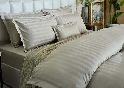 7-piece duvet cover set featuring beige striped duvet and square striped pillow shams