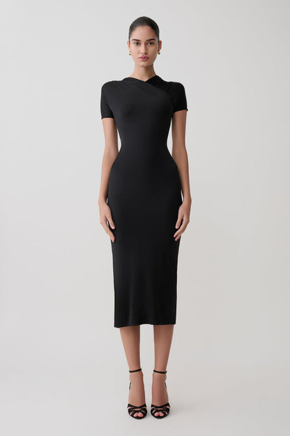 Woman wearing a black dress on a white background.
