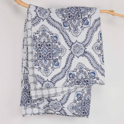 Lentana Navy Quilted Throw showcasing intricate medallion pattern in navy and white, perfect for cozy decor.