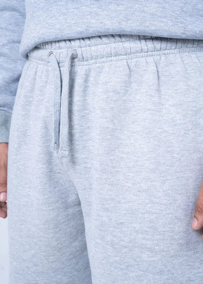 Light grey fleece shorts close-up: elastic waist with drawstring and stitched hem