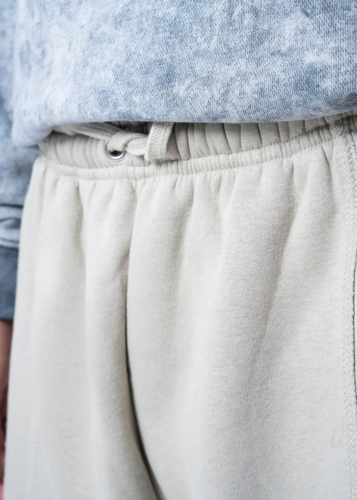Men's casual knit shorts waistband close-up with elastic and drawstring eyelet