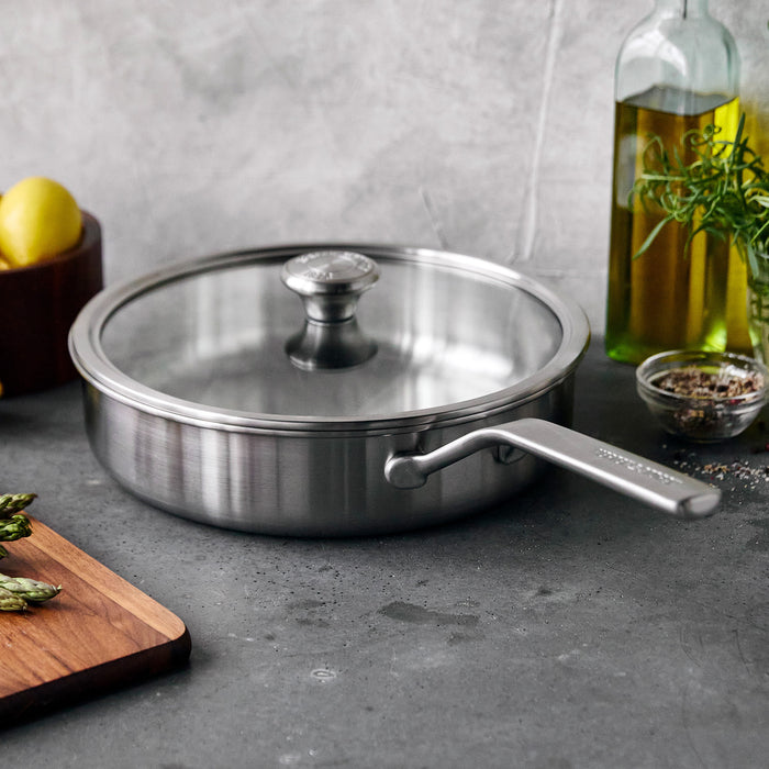Stainless steel sauté pan with lid, 3.5-quart size, silver finish, shown on a countertop.