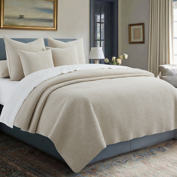 Pick-Stitch Artisan Quilt Set displayed on a bed with multiple pillows, showcasing a relaxed, textured design.
