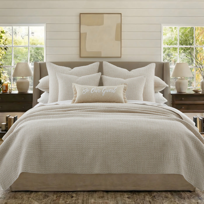 A beautifully styled bed featuring the Pick-Stitch Artisan Square Pillow and a cozy, inviting decor.