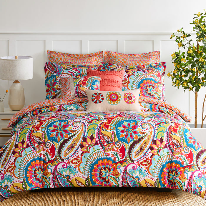 Colorful paisley patterned boho duvet cover set on a bed with a white headboard.