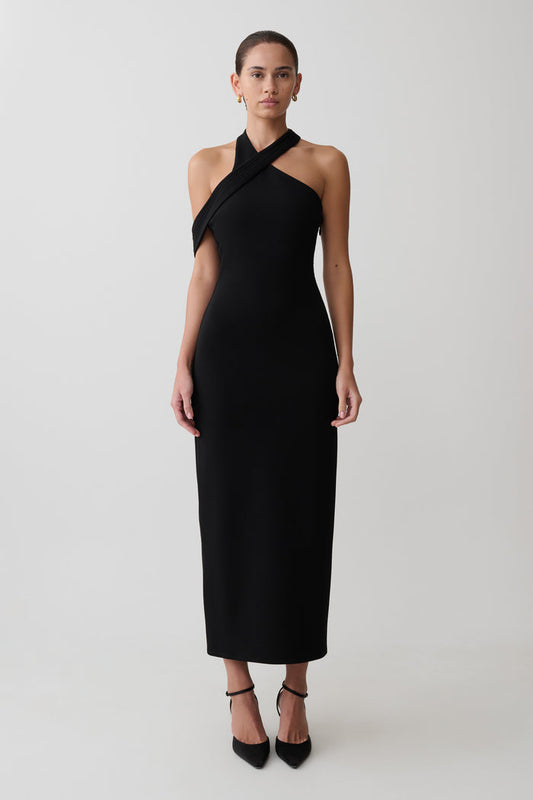 Woman wearing black crossover neck dress.