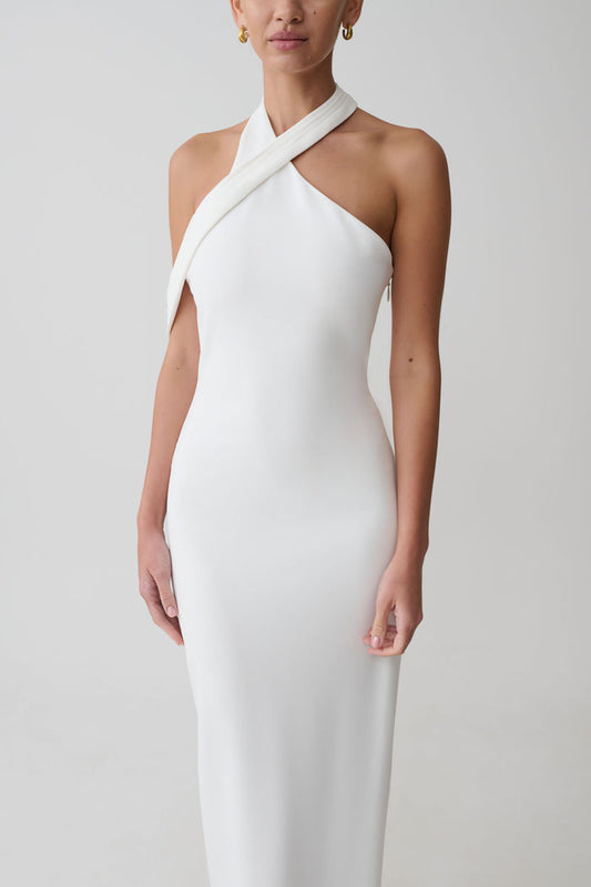 Woman wearing white crossover neck dress.