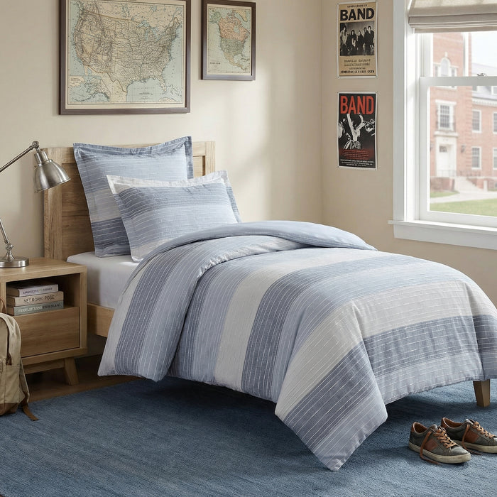 Bedroom with blue and white striped bedding, nightstand, and window.