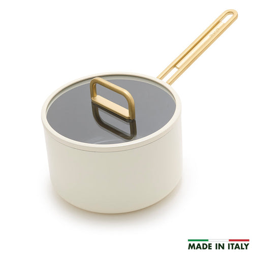 White ceramic 4-quart saucepan with lid and gold handle, shown in Carrara white finish.