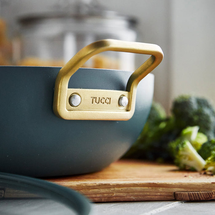 Venetian Teal ceramic nonstick 6.5-quart pan next to chopped broccoli on a wooden cutting board.