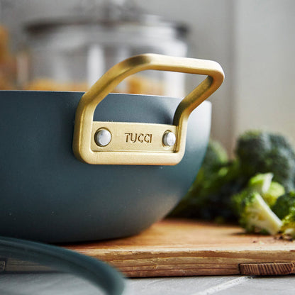 Venetian Teal ceramic nonstick 6.5-quart pan next to chopped broccoli on a wooden cutting board.