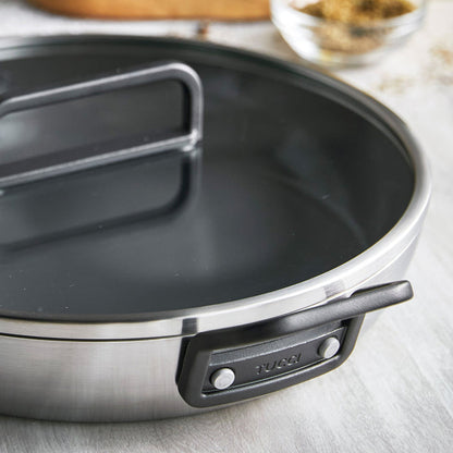Stanley Tucci 12-inch stainless steel frypan with black handle and matching lid shown on a countertop.