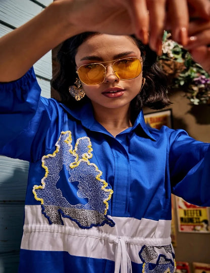 Wild Royal Blue Shirt Dress with abstract blue and yellow embroidery, contrasting white drawstring waist panel, and three-quarter sleeves in a chic relaxed silhouette.