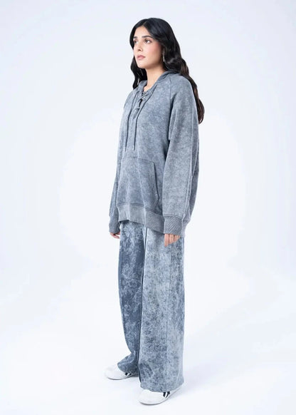 Women's charcoal terry pullover hoodie with drawstring, side view with wide-leg pants