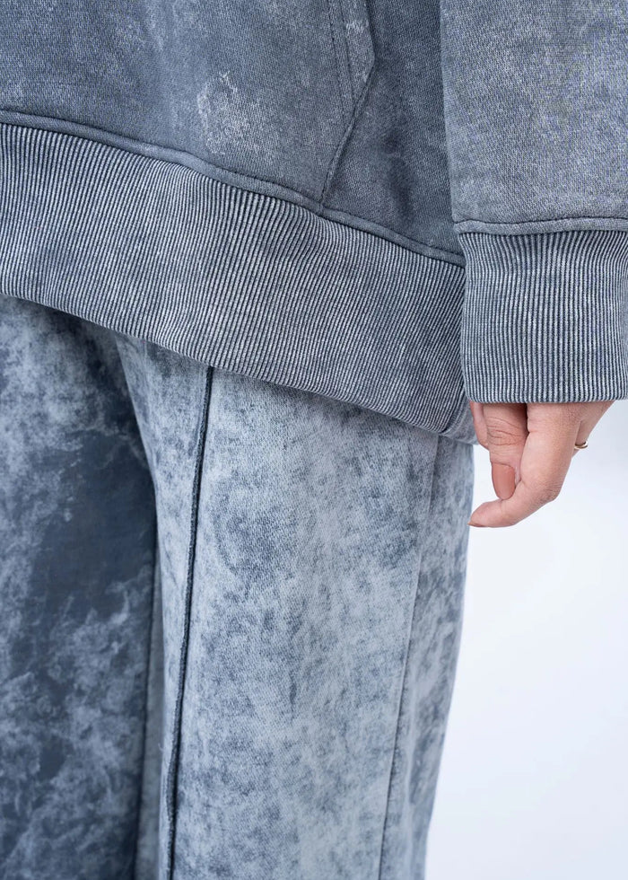 Charcoal terry wide-leg pants close-up with elastic rib cuffs and side seam